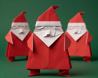 Könnte beinhalten: Drei Origami-Figuren in Form des Weihnachtsmanns, jeweils aus rotem und weißem Papier gefaltet. Die Figuren haben eine spitze rote Mütze, einen weißen Bart und einen roten Mantel. Sie sind mit einer Figur im Vordergrund angeordnet.