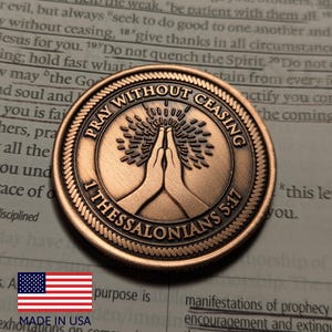 May include: A white ceramic mug with a black handle and the text "But First, Coffee" in a bold, black font. The mug is set against a blurred background, suggesting a cozy setting.