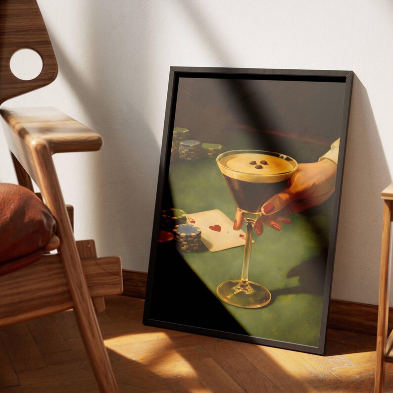 May include: A framed vertical art print depicting a dark-toned scene of a hand holding an espresso martini glass with three coffee beans on top. The composition includes a green poker table surface, stacks of colorful poker chips, and an ace card.