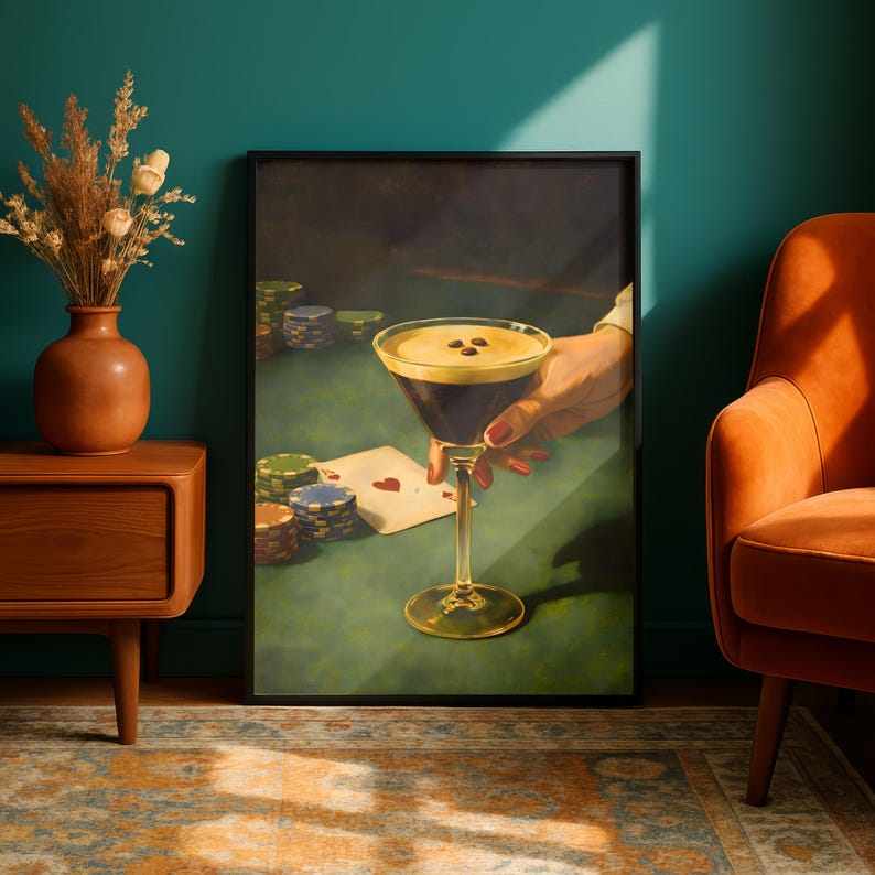 Vertical espresso martini art print displayed in a moody teal room with a mid-century modern orange armchair, creating a vibrant focal point for bar cart decor and speakeasy wall art aesthetic.
