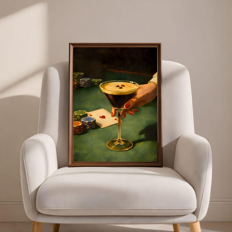 Vertical espresso martini wall art in a thin brown frame, placed on a modern white curved armchair, showcasing a minimalist luxury speakeasy decor and aesthetic cocktail wall art for a trendy living room.