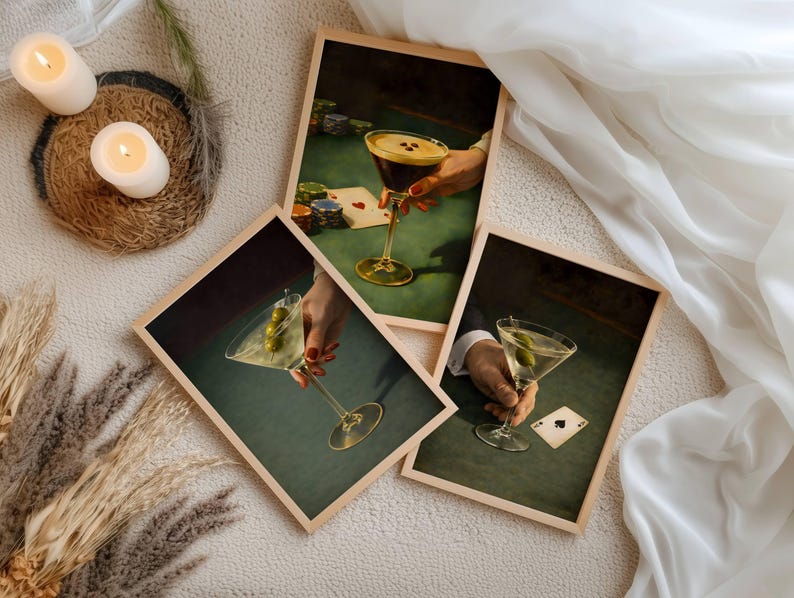 A collection of vintage martini prints and poker wall art series featuring espresso martini and dirty martini designs, styled with candles and pampas grass for a cohesive bar cart decor gallery wall set.