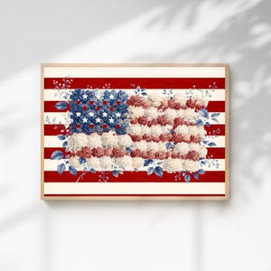 May include: Framed artwork featuring a floral American flag design. The flag's stripes are red and white, while the stars are represented by white stars on a blue floral background. The flag's stripes are made of red and white flowers.