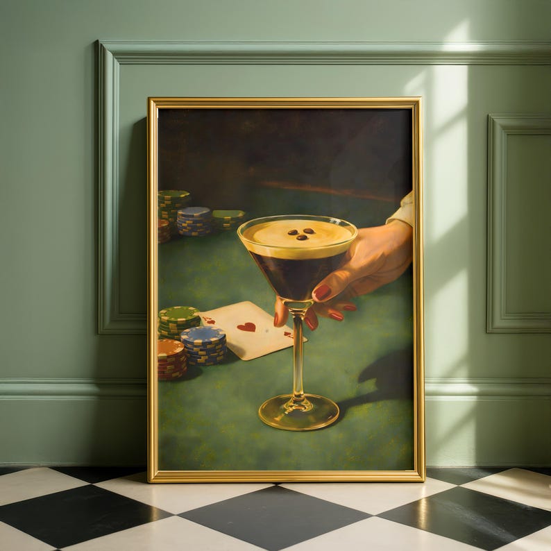 Vertical espresso martini art print in a gold frame, leaning against a mint green paneled wall on a black and white checkered floor for a vintage glam and grandmillennial bar decor aesthetic.