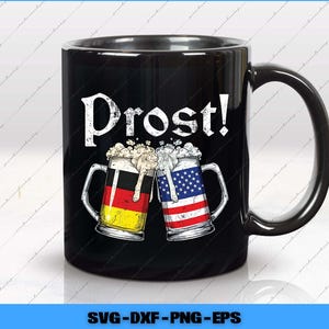 May include: Black ceramic mug with the word "Prost!" in white script. The mug features two beer steins clinking, one with the German flag and the other with the American flag. The steins are filled with foamy beer.