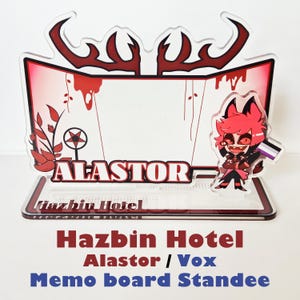 May include: A clear acrylic Hazbin Hotel memo board standee featuring the character Alastor. The standee has a red and white colour scheme, with the character's name prominently displayed. The standee also includes the text "Hazbin Hotel" and "Memo board Standee".
