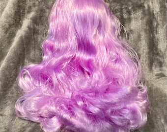 May include: A long, wavy, purple wig for a doll. The wig is made of synthetic hair and has a natural, flowing look.