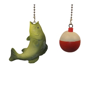 May include: Two decorative ceiling fan pulls. One is a green fish, the other a red and white bobber. Both are suspended by a silver chain. The fish has a detailed scale pattern.