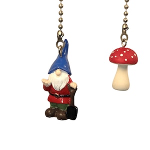 May include: Two decorative fan pulls. One is a garden gnome with a blue hat, red coat, white beard, and a shovel. The other is a red mushroom with white spots. Both are attached to silver ball chains.