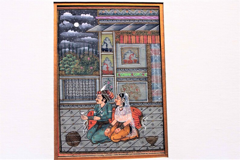May include: A traditional Indian miniature painting depicting a couple in a palace setting. The painting is done in vibrant colors and features intricate details. The couple is seated on a balcony overlooking a garden, with a full moon in the sky.