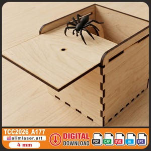 Puede incluir: Una caja de madera clara con tapa abatible y una araña de plástico negro. La caja tiene un diseño geométrico simple. El texto "TCC2026_A177" y "4 mm" son visibles.