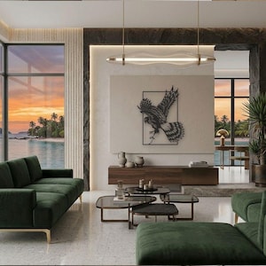 May include: A living room featuring two dark green velvet sofas, a low wooden media console, and a set of three tiered coffee tables with dark glass tops. A black metal eagle wall art piece hangs above the console under a linear pendant light.