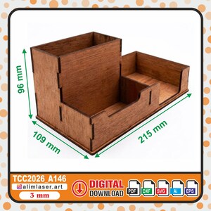 May include: A brown wooden desk organizer with multiple compartments, featuring a height of 96 mm, a width of 109 mm, and a length of 215 mm. The structure is made of 3 mm thick material, designed for digital download in PDF, DXF, SVG, Ai, and EPS formats.
