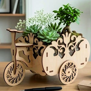 May include: A light-colored wooden planter shaped like a tricycle with intricate laser-cut floral patterns on the sides. The planter holds a variety of green succulents and a small leafy plant, creating a decorative display for indoor spaces.