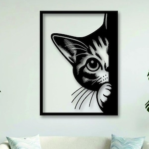 May include: A rectangular wall art piece featuring a high-contrast black and white graphic illustration of a cat peeking from behind a vertical edge. The design shows one eye, a pointed ear, whiskers, and a paw, all rendered in bold black lines.