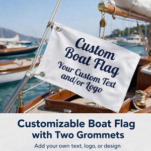 May include: A white boat flag with navy blue text that reads "Custom Boat Flag" and "Your Custom Text and/or Logo." The flag is attached to a boat mast with two grommets. The background shows a boat and the sea.