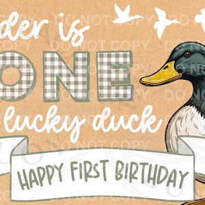 May include: A birthday-themed graphic with a duck illustration. Text includes "Ryder is ONE lucky duck" and "Happy First Birthday." The background is tan with cattails, grass, and flying duck silhouettes.