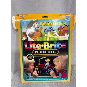 May include: A yellow Lite-Brite Picture Refill box with the words "Barnyard Fun" and "Lite-Brite" in large letters. The box features illustrations of farm animals and children using the toy. The box contains 12 Lite-Brite pictures and 24 guide sheets.