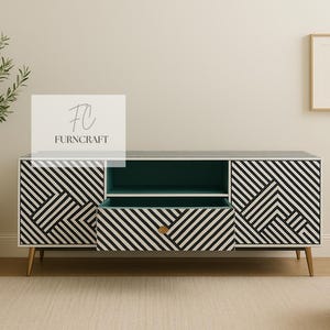 May include: Modern black and white geometric patterned media console with a teal interior. The console has a drawer and two doors, with gold-toned legs. The brand name "FURNCRAFT" is visible on the top left.