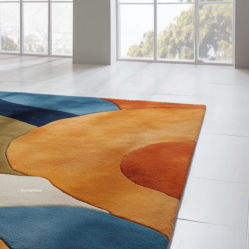 May include: A colorful area rug with an abstract design. The rug features a combination of blue, orange, and green hues in a flowing, organic pattern. The rug is made of a soft, plush material and is designed for indoor use.