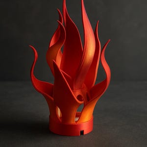 May include: A vibrant, stylized sculpture resembling flames. The artwork features a base with a series of upward-reaching, flame-like forms in shades of red and orange. The sculpture is set against a dark background.