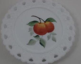 May include: White milk glass plate with a scalloped edge and a painted design of two red apples with green leaves.