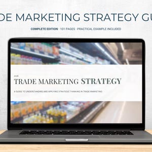 May include: A laptop displaying a digital document titled TRADE MARKETING STRATEGY, A GUIDE TO UNDERSTANDING AND APPLYING STRATEGIC THINKING IN TRADE MARKETING. Above the screen, the text reads TRADE MARKETING STRATEGY GUIDE, COMPLETE EDITION, 101 PAGES.