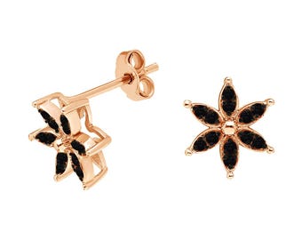 May include: Rose gold flower stud earrings with black gemstone petals. The earrings feature a six-petal design with a post backing. The jewelry is set against a white background, highlighting the contrast of colors and the intricate details.