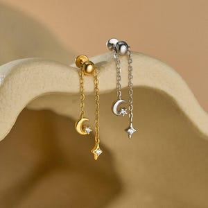 May include: A white ceramic mug with a black handle and the text "But First, Coffee" in a bold, black font. The mug is set against a blurred background, suggesting a cosy setting.