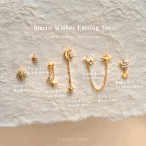 Könnte beinhalten: Starlit Wishes Ohrring-Set aus der Starlit Galaxy Kollektion mit sechs goldfarbenen Ohrring-Stilen: North Star, Little Stella, Twin Wishes, Moonlit Star, Opal Glow und Celestial Bloom, jeweils verziert mit klaren Steinen oder Opalen.