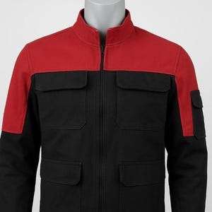 May include: A black and red jacket with a stand-up collar and a full-length zip. The jacket has a red yoke and sleeves, with black panels and four front pockets. The jacket is displayed on a mannequin.