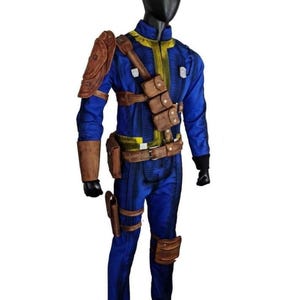 May include: A blue and yellow jumpsuit with brown leather accents, including shoulder armor, pouches, and a belt. The costume is displayed on a black mannequin, showcasing a detailed design.