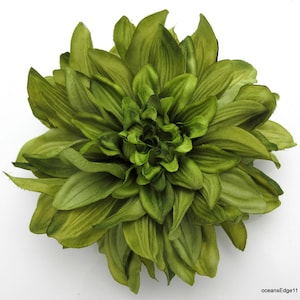May include: A large, green silk flower with many petals. The flower is made of fabric and has a realistic appearance.