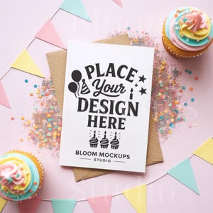 May include: A white card with the text "PLACE Your DESIGN HERE" sits on a brown envelope, surrounded by confetti, cupcakes, and a pastel-colored banner. The card is a mockup from Bloom Mockups Studio.