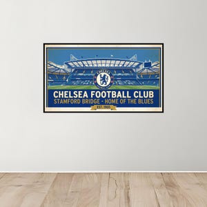May include: A framed poster featuring Stamford Bridge, the home of Chelsea Football Club. The image showcases the stadium in a vintage style, with the club's logo prominently displayed. Text includes "Chelsea Football Club" and "Home of the Blues."
