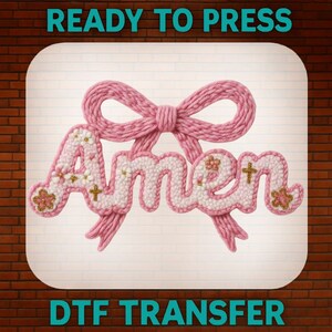 May include: A pink knitted bow with the word "Amen" in a white and pink floral design. The image includes the text "READY TO PRESS" and "DTF TRANSFER".