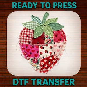 May include: A colorful strawberry-shaped DTF transfer with a patchwork design. The strawberry features various fabric patterns, including gingham, floral, and heart prints, in shades of red, pink, and white. The text "READY TO PRESS" and "DTF TRANSFER" are displayed.
