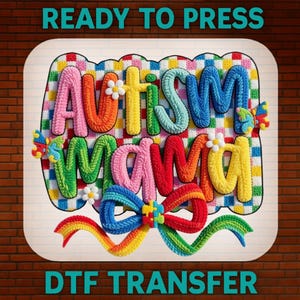 May include: A colorful graphic with the words "AUTISM MAMA" in a textured, 3D style. The design includes a rainbow-colored bow and the text "READY TO PRESS" and "DTF TRANSFER". The background is a checkered pattern with floral accents.