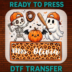 May include: A DTF transfer design featuring a skeleton and a ghost wearing orange baseball caps, a baseball glove with a ball, a wooden bat, and a bat-winged pumpkin. Below, a rectangular orange leopard print frame contains the text Mrs. Olivia.