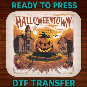 May include: A square DTF transfer sheet featuring the text HALLOWEENTOWN at the top. The illustration depicts a large jack-o'-lantern in the center of a town square with buildings, smaller pumpkins, and flying bats against an orange sky.