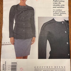 May include: A vintage Geoffrey Beene Vogue American Designer sewing pattern. The pattern shows a woman in a grey jacket and skirt. The jacket has a round neckline and button closures. The pattern includes the text "Puffed tubing wraps the shoulder, arm and waistline."