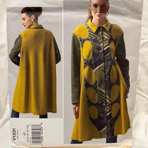 May include: A Vogue Patterns American Designer sewing pattern featuring a long coat design. The coat is mustard yellow with patterned panels and sleeves. The pattern number is V1331, size A5 (6-8-10-12-14).
