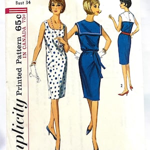 May include: Vintage Simplicity sewing pattern featuring three dress designs. The pattern includes a polka dot dress, a sailor-style dress, and a sheath dress. The pattern is size 14 with a 34-inch bust and is priced at 65 cents in Canada.