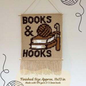 May include: Crocheted wall hanging with the words "BOOKS & HOOKS" in brown on a tan background. The design includes a yarn ball and a crochet hook. The finished size is approximately 28x33 cm.