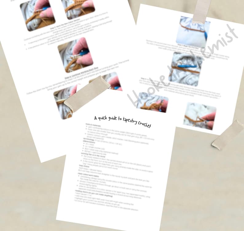May include: A guide to tapestry crochet, with instructions and photos. The guide is printed on white paper and secured with tape. The text "Hooked Alchemist" is visible. The text "A quick guide to tapestry crochet" is also visible.