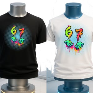 May include: Black and white t-shirts with a colorful graphic design. The design features the numbers "67" in a dripping style, with two hands below. The numbers and hands are in bright colors, including green, orange, and pink.
