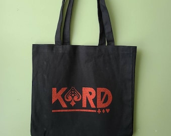 May include: Black canvas tote bag with red K.A.R.D. logo and playing card symbols.