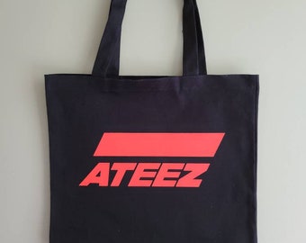 May include: Black canvas tote bag with red ATEEZ logo printed on the front.