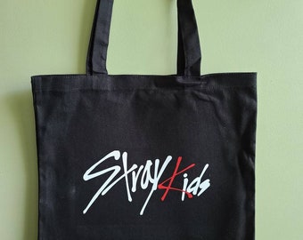 May include: Black canvas tote bag with white and red "Stray Kids" logo.