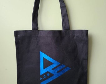 May include: A black canvas tote bag with blue handles and a blue triangle logo that says "A.C.E."